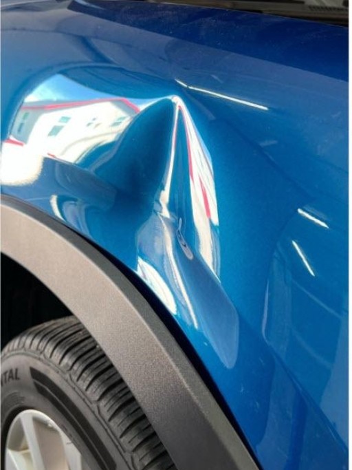 Before repair - dented fender